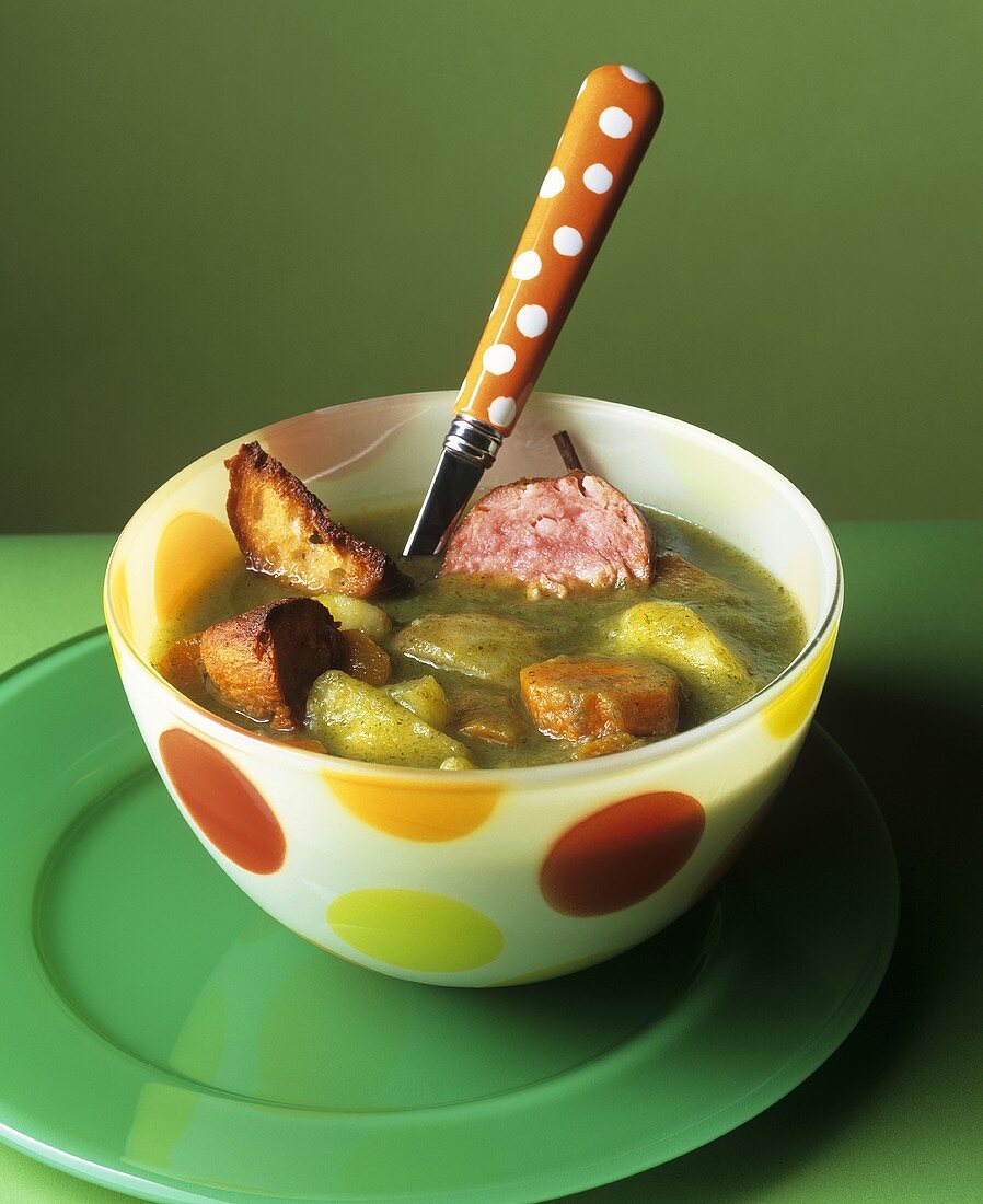 Spinach and vegetable soup with sausage