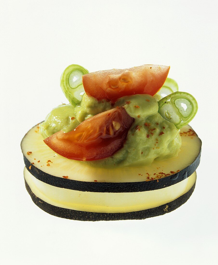 Aubergine slices with avocado cream and tomato