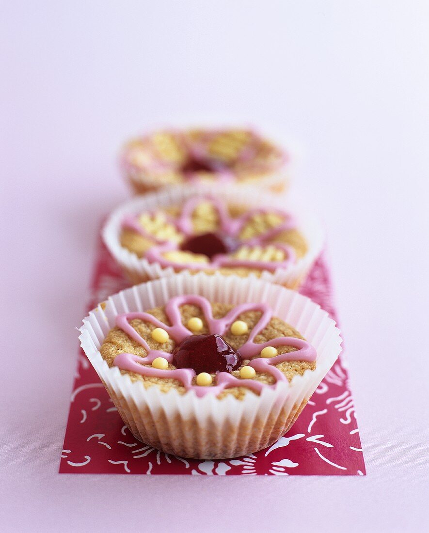 Three muffins with iced flowers