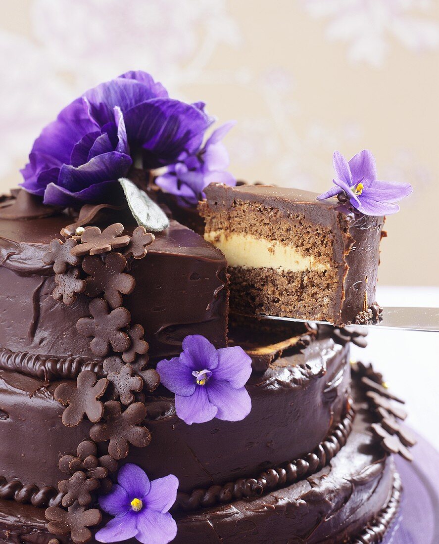 Three-tiered chocolate cake with flowers