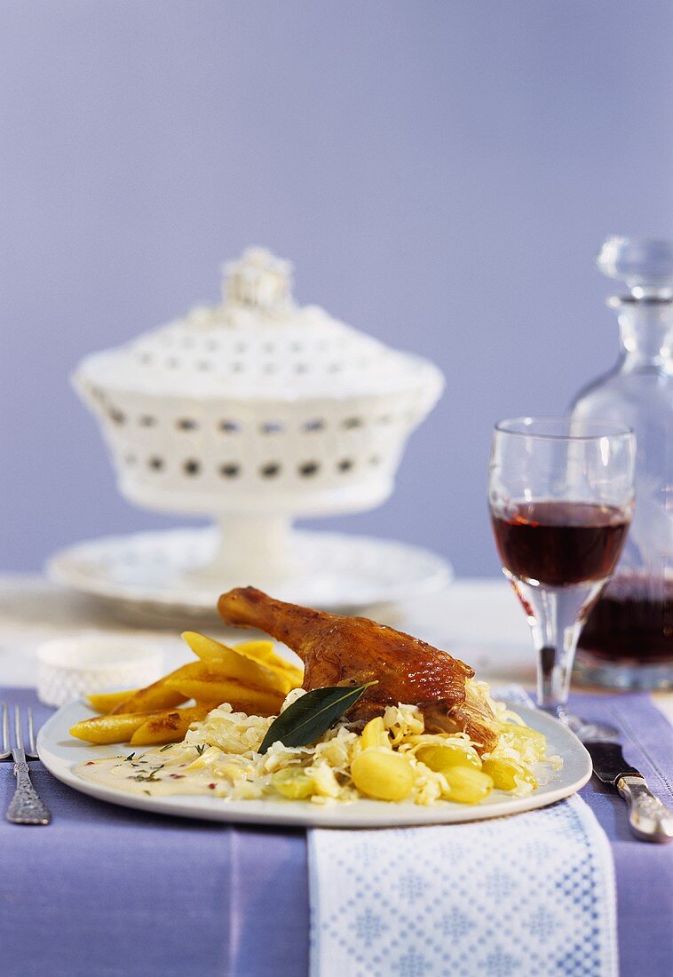 Duck leg on champagne sauerkraut with cream sauce, potato noodles