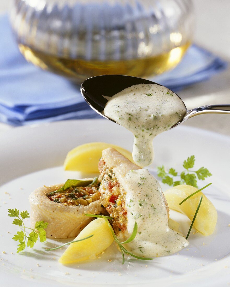 Steamed trout fillet with vegetable stuffing and herb sauce