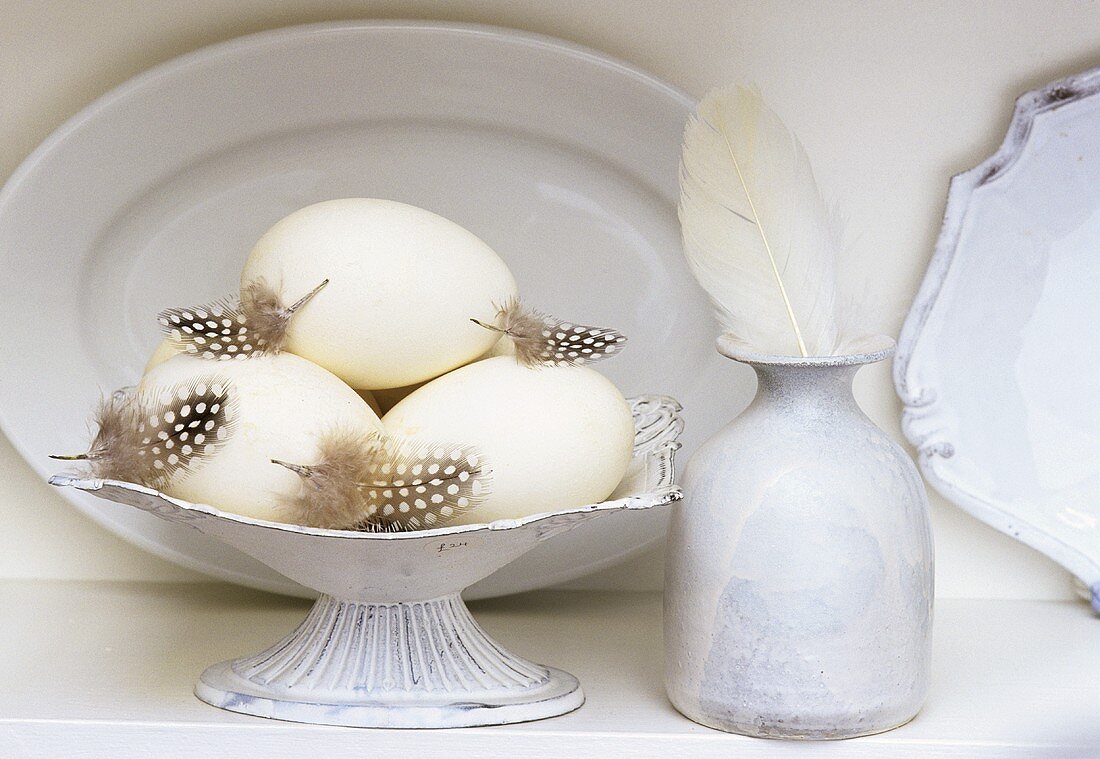 White still life with crockery, goose eggs and feathers