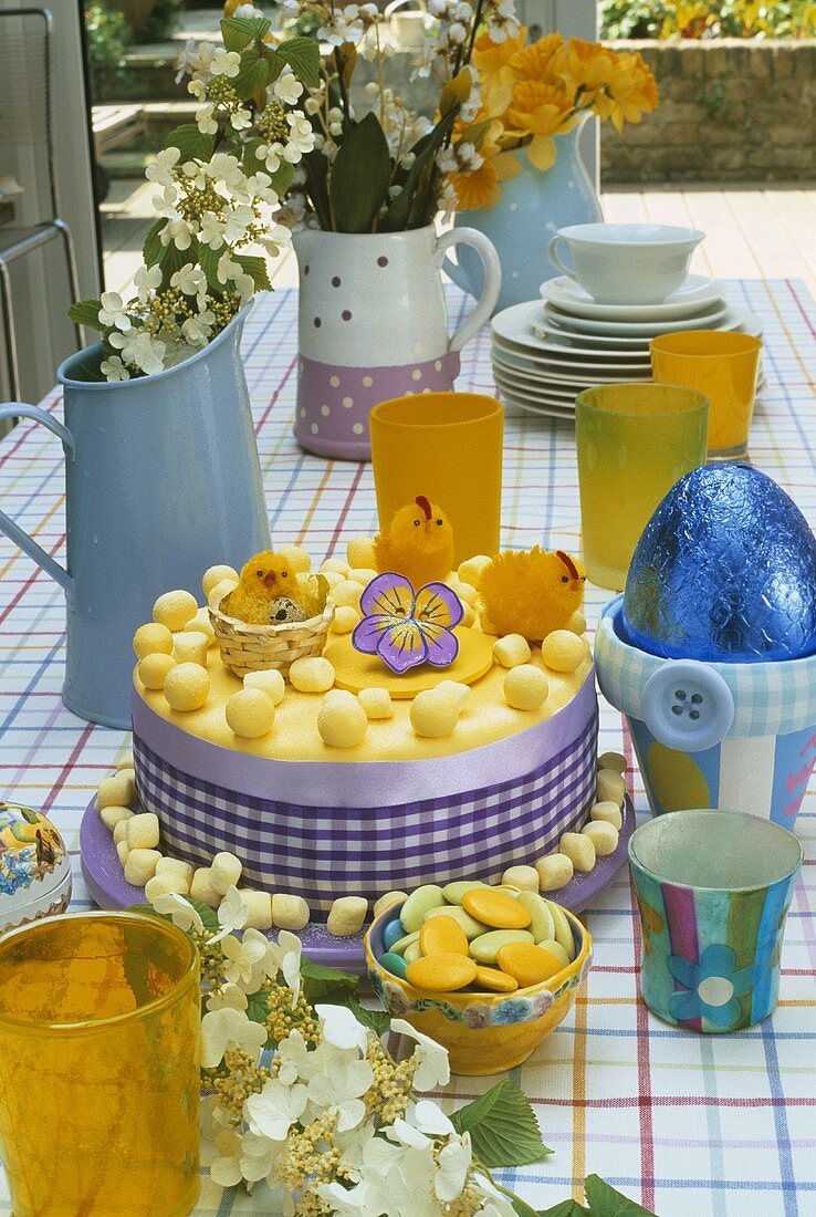 Easter cake on decorated table on terrace