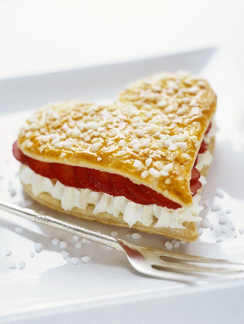 Puff pastry heart filled with strawberries and whipped cream