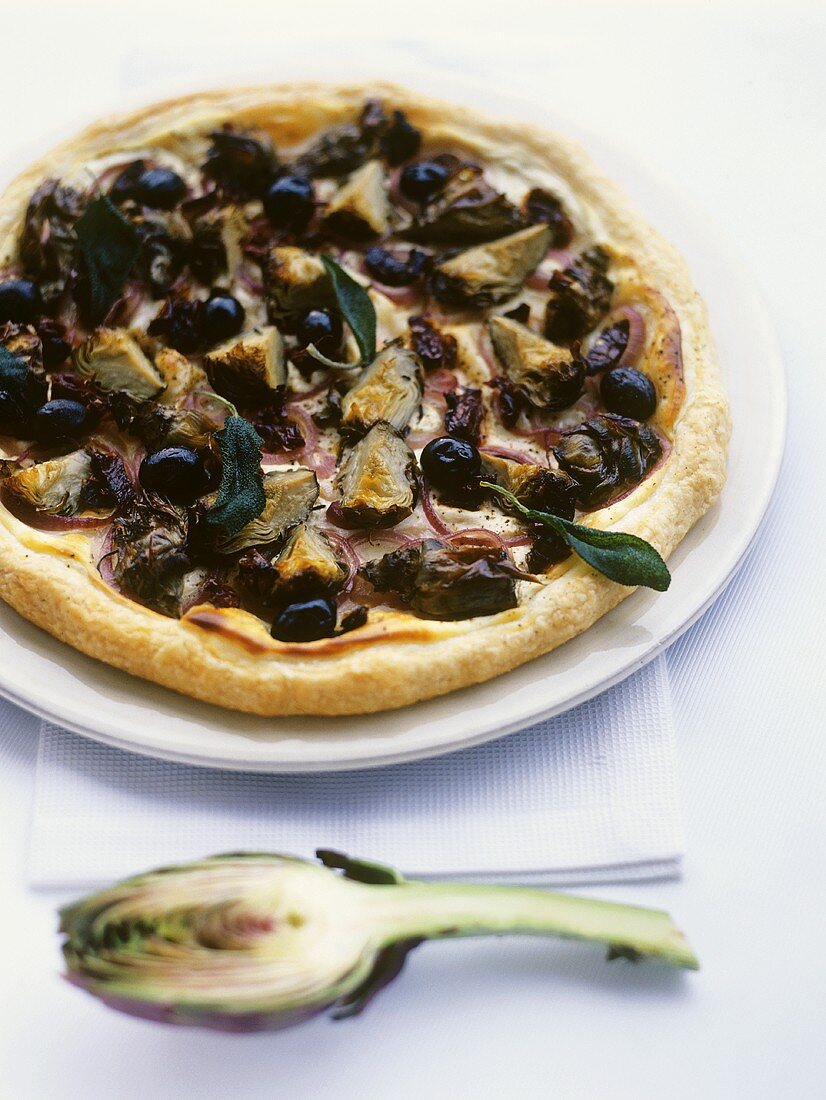 Artichoke pizza with olives, onion rings and sage