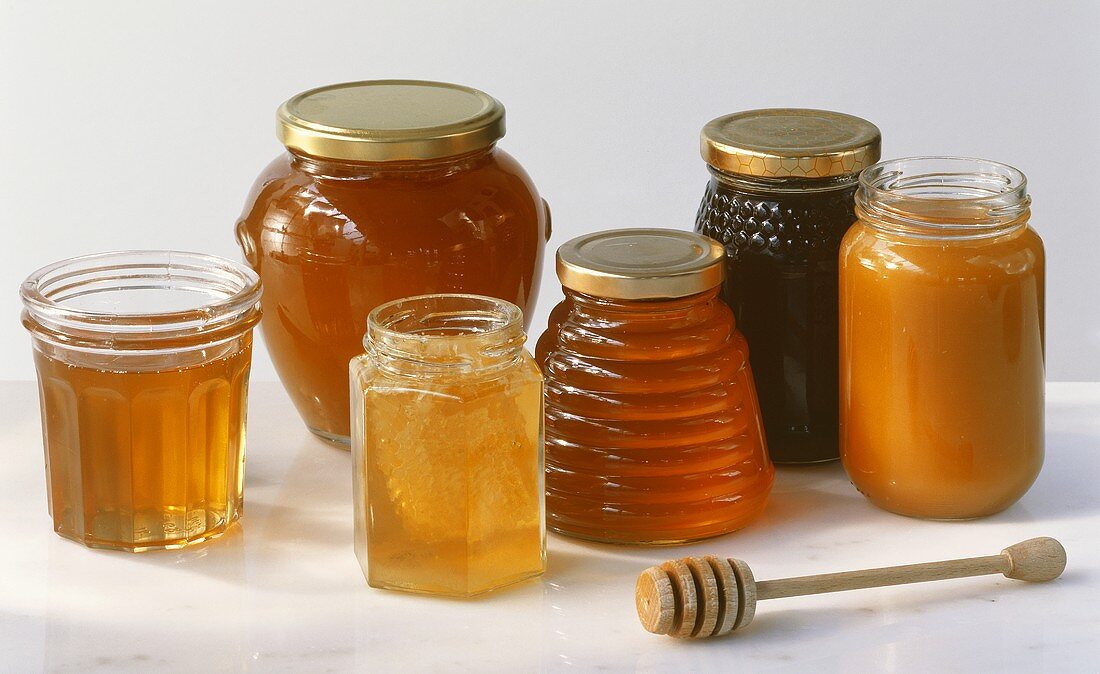 Various types of honey in screw-top jars