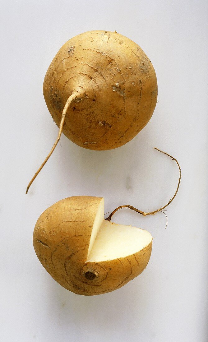 Two yams, one with a section removed
