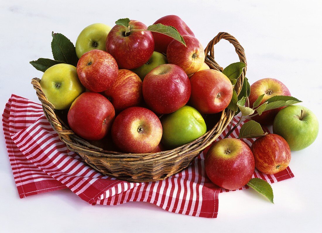 Green and red apples in a basket