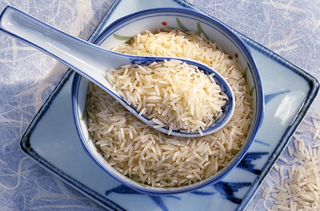 Basmati rice in Asian bowl and porcelain spoon