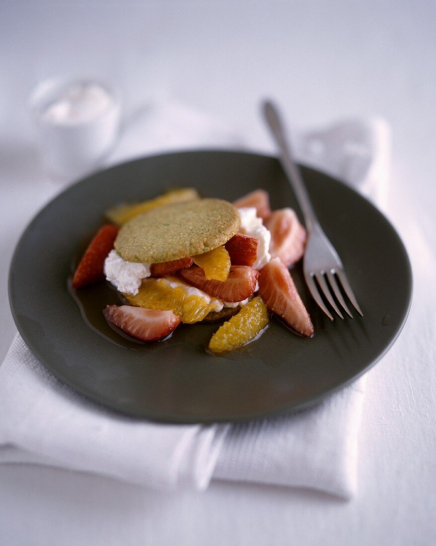 Orange and strawberry salad with pistachio biscuit