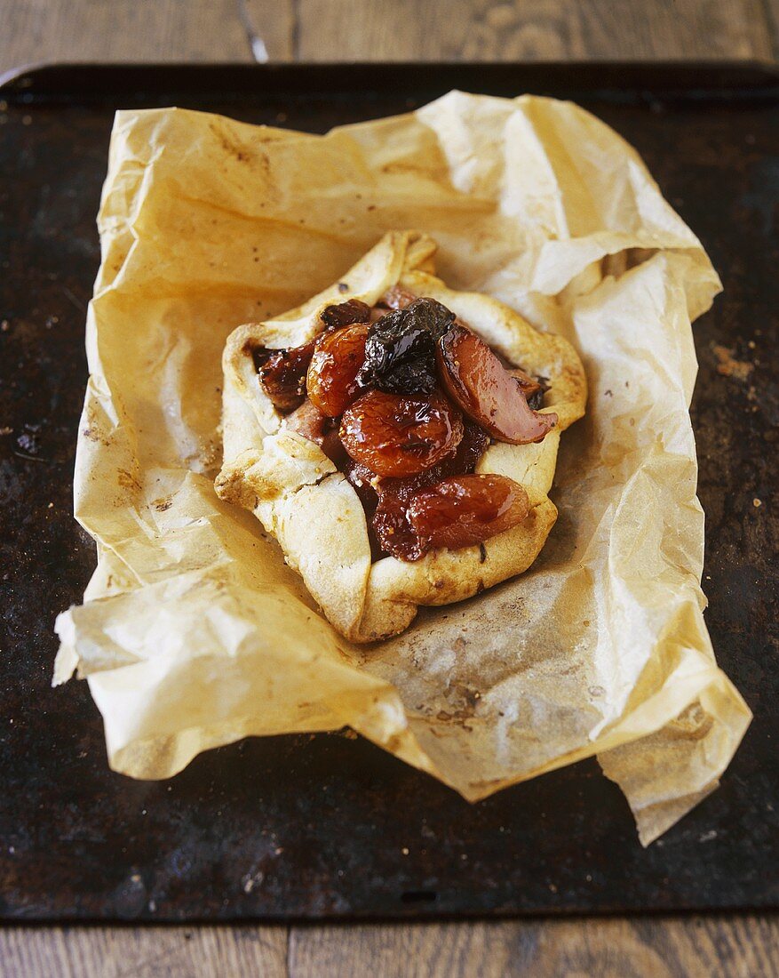 Dried fruit tart on baking parchment