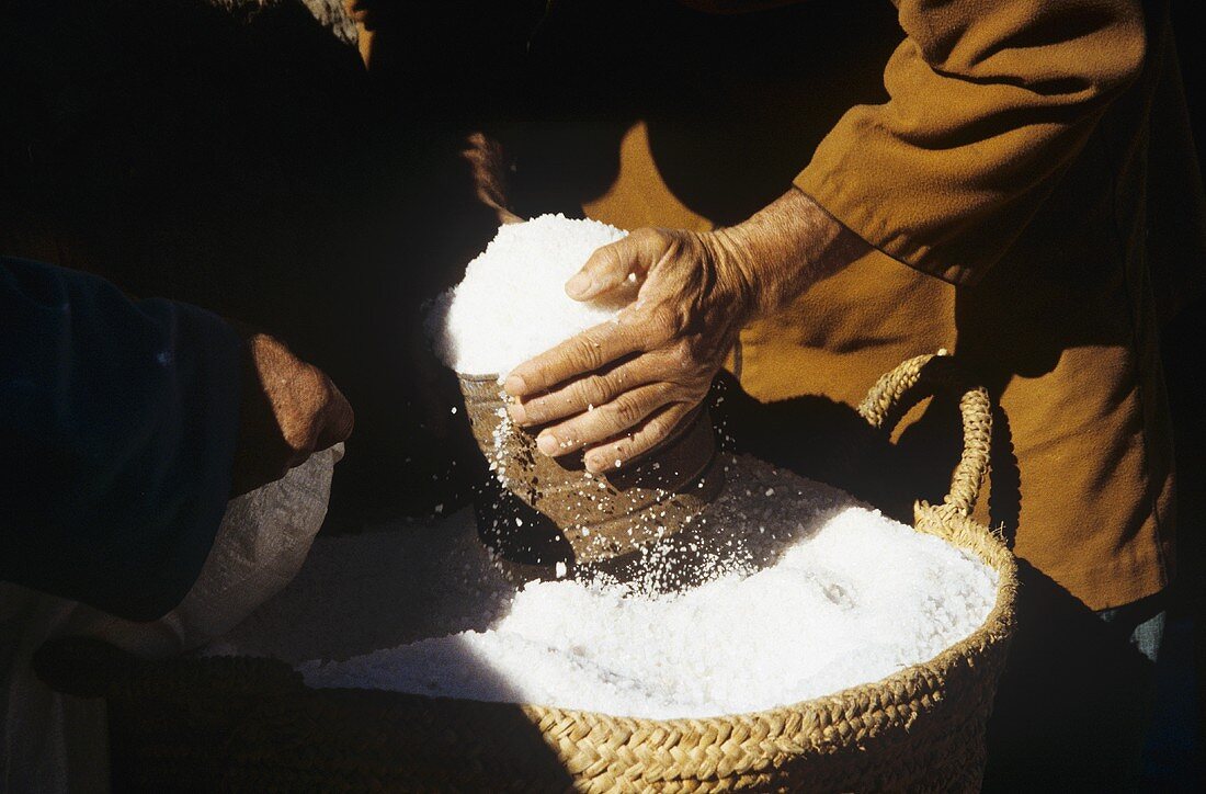 Putting sea salt into a bag at a market