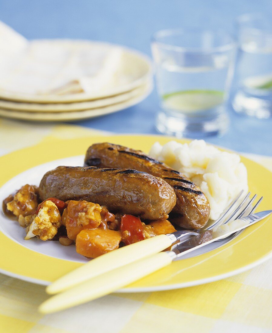 Grilled sausages with mashed potato and vegetables