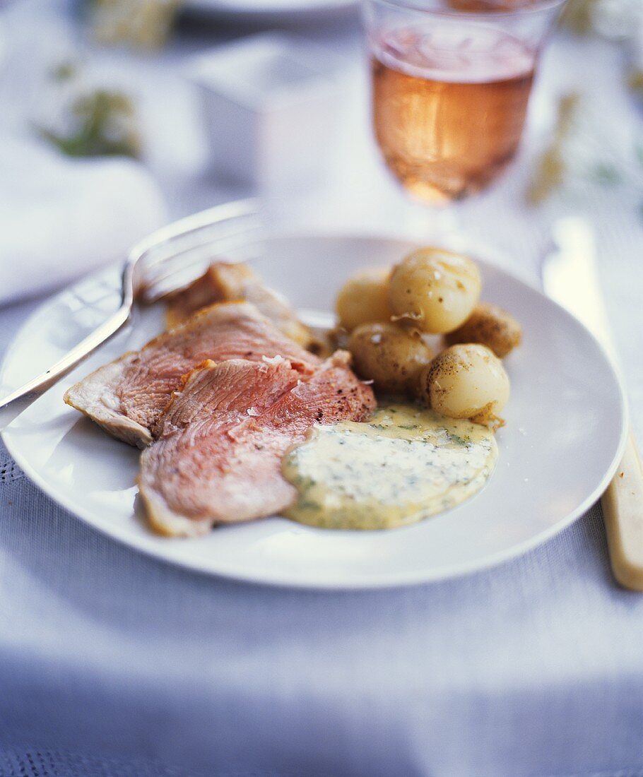 Roast lamb with potatoes and herb sauce
