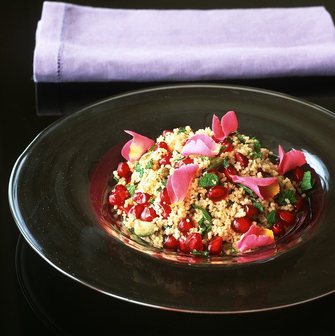 Couscous with pomegranate seeds and rose petals