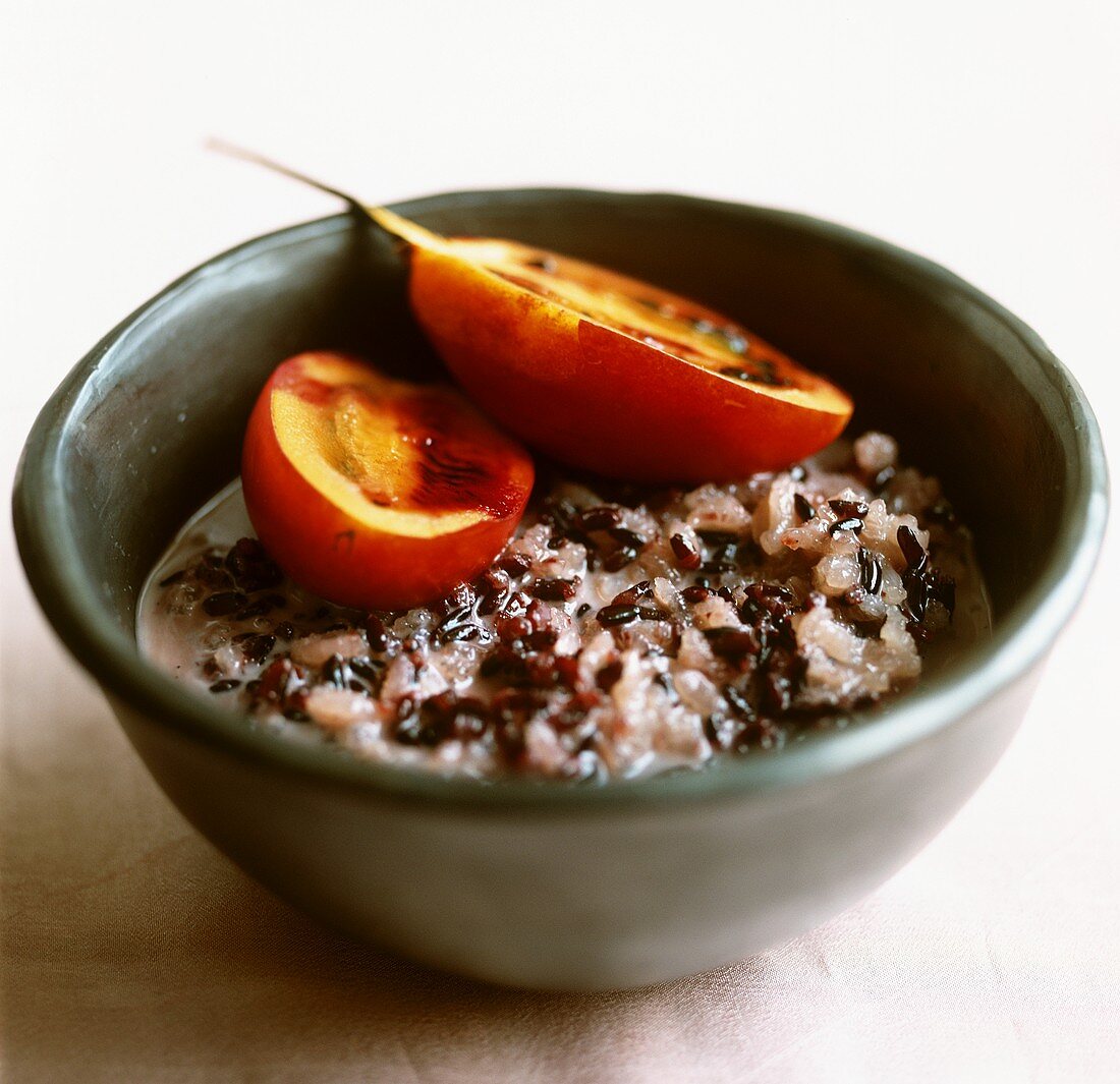 Sweet rice and sesame seeds in coconut milk with tamarillo