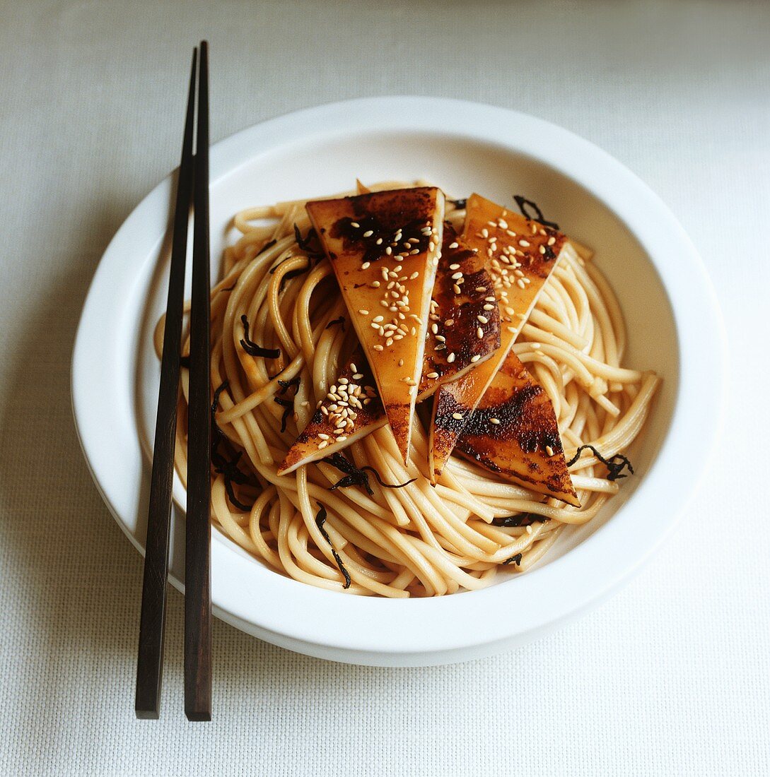 Squid with sesame seeds on noodles