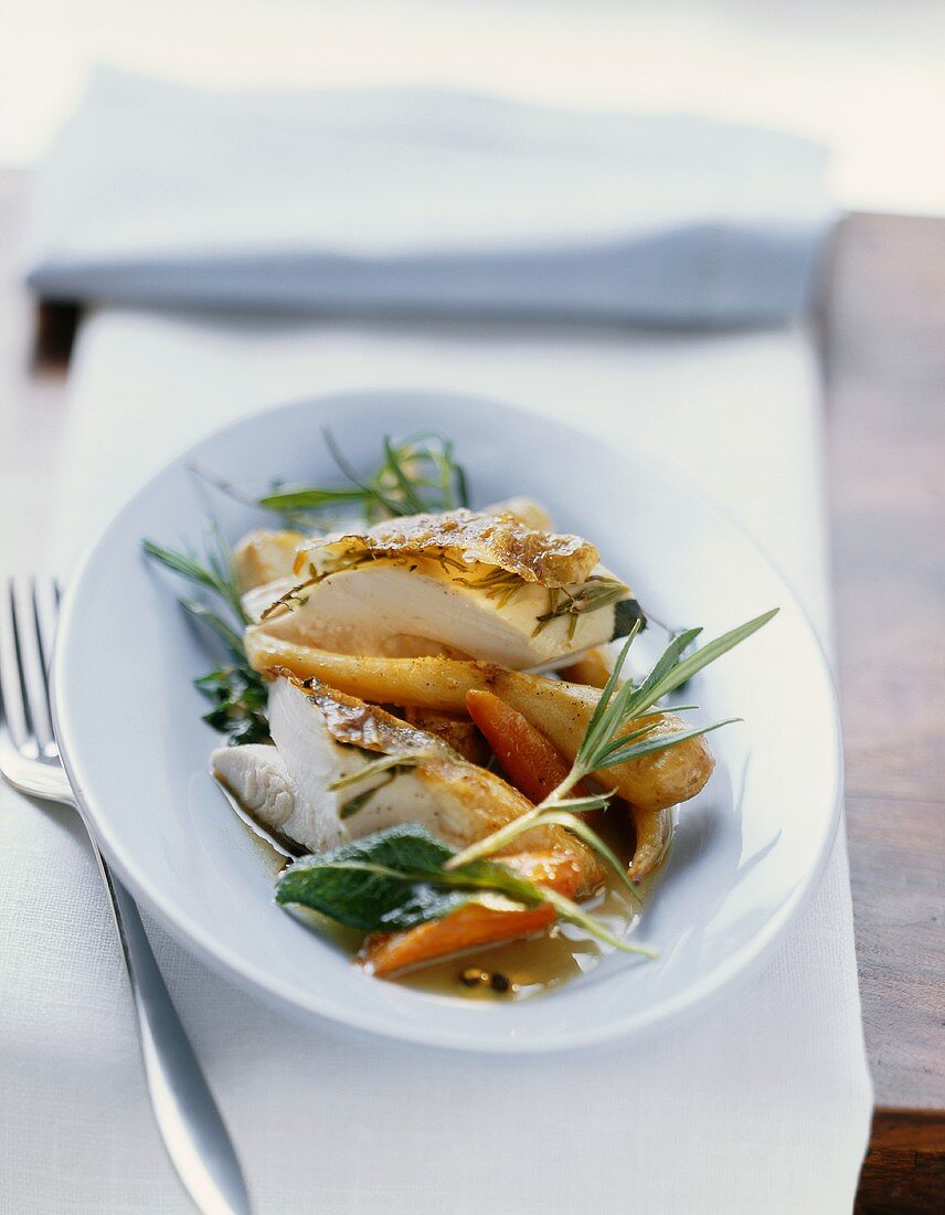 Roast chicken with herbs stuffed under the skin with vegetables