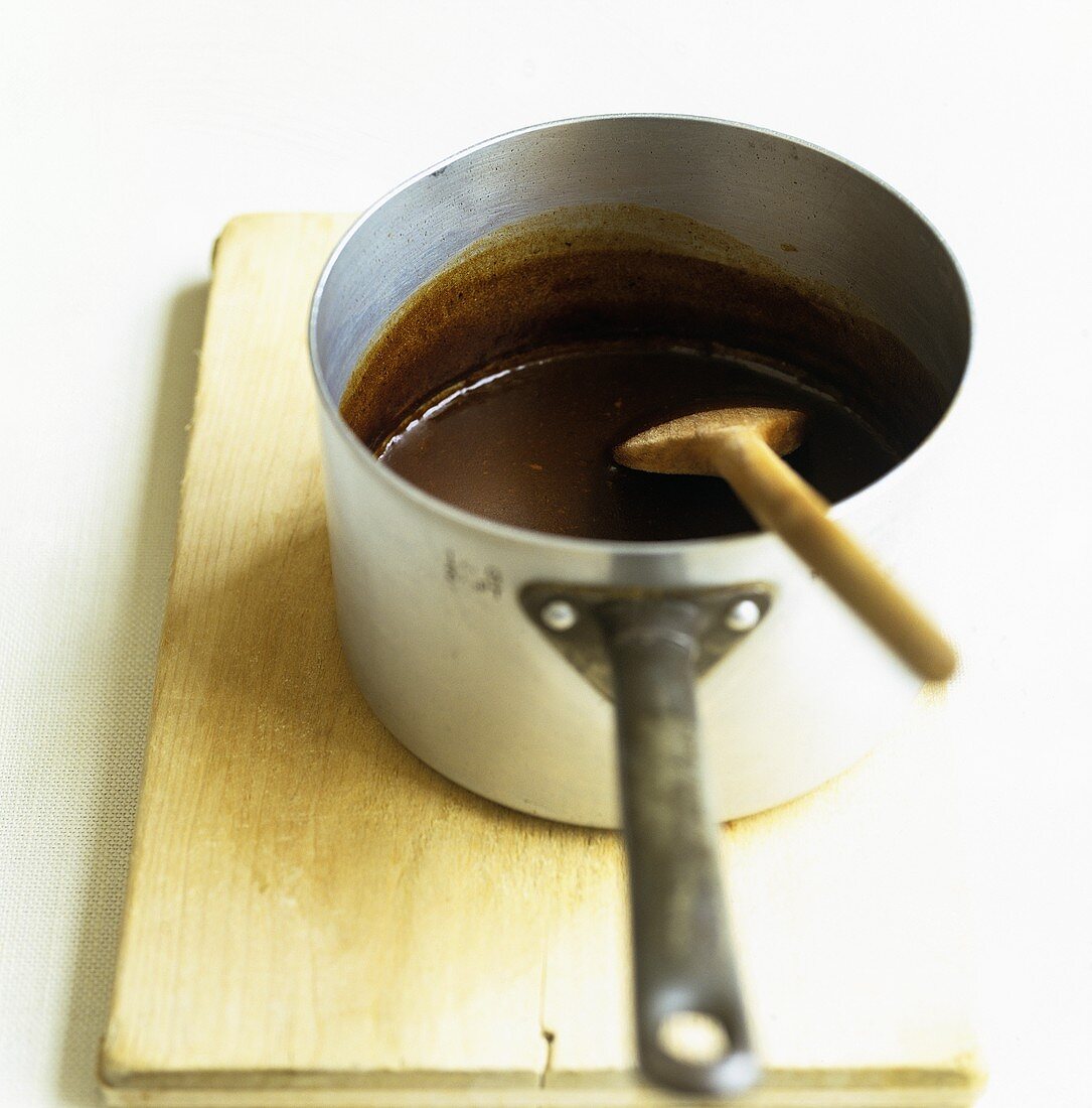 Gravy in a saucepan with a wooden spoon