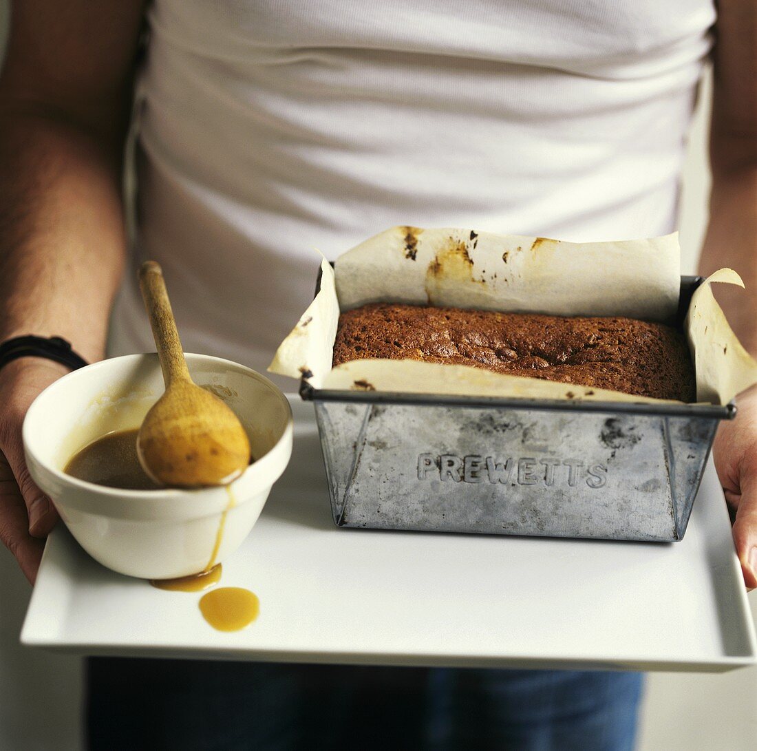 Sticky toffee pudding with caramel sauce on a tray