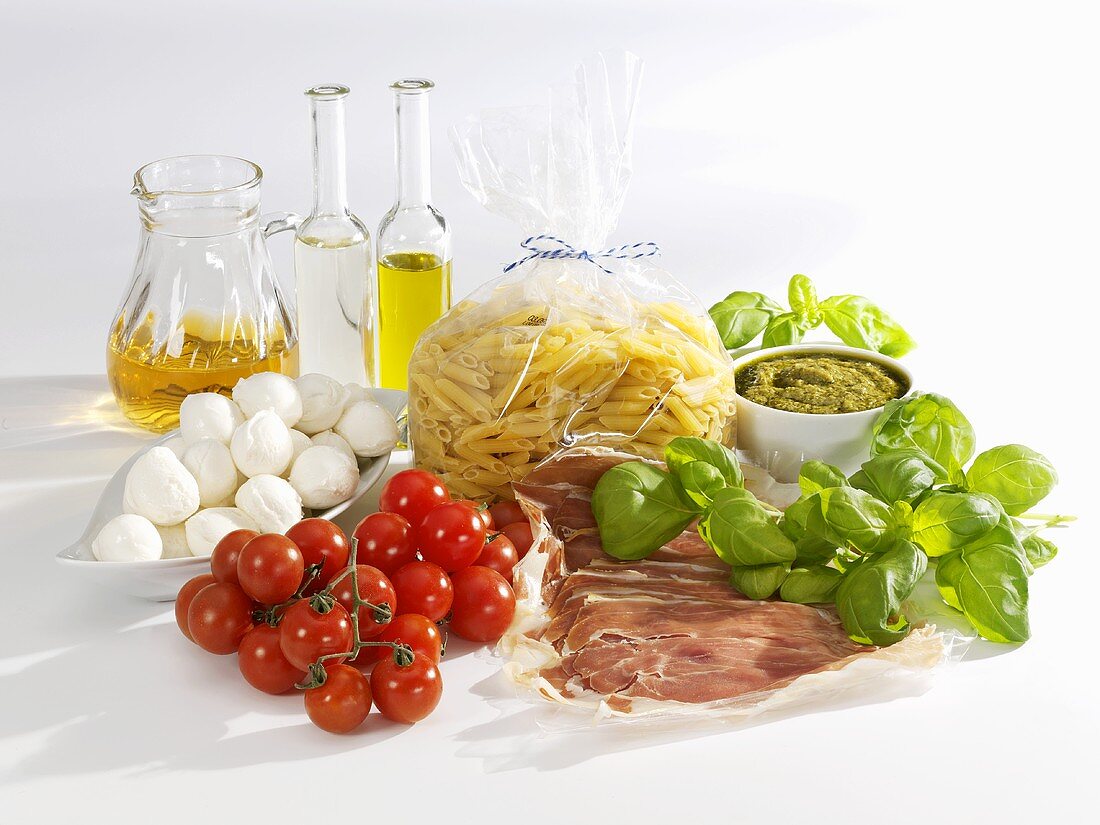 Ingredients for pasta salad with mozzarella, tomatoes, Parma ham