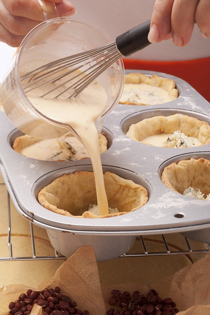 Tartlets being made in a muffin tin