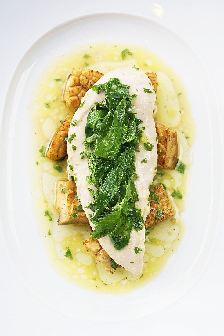 Chicken breast with wild herb spinach on a bed of fried mushrooms