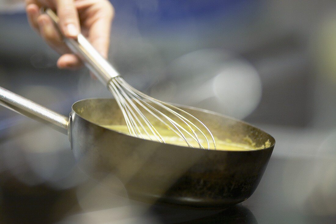 Soup being mixed with a whisk