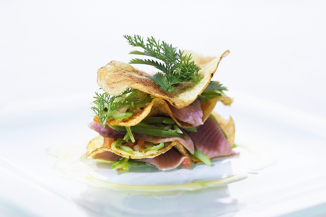 Crispy potato chips with soused herring, beans and meadow herbs