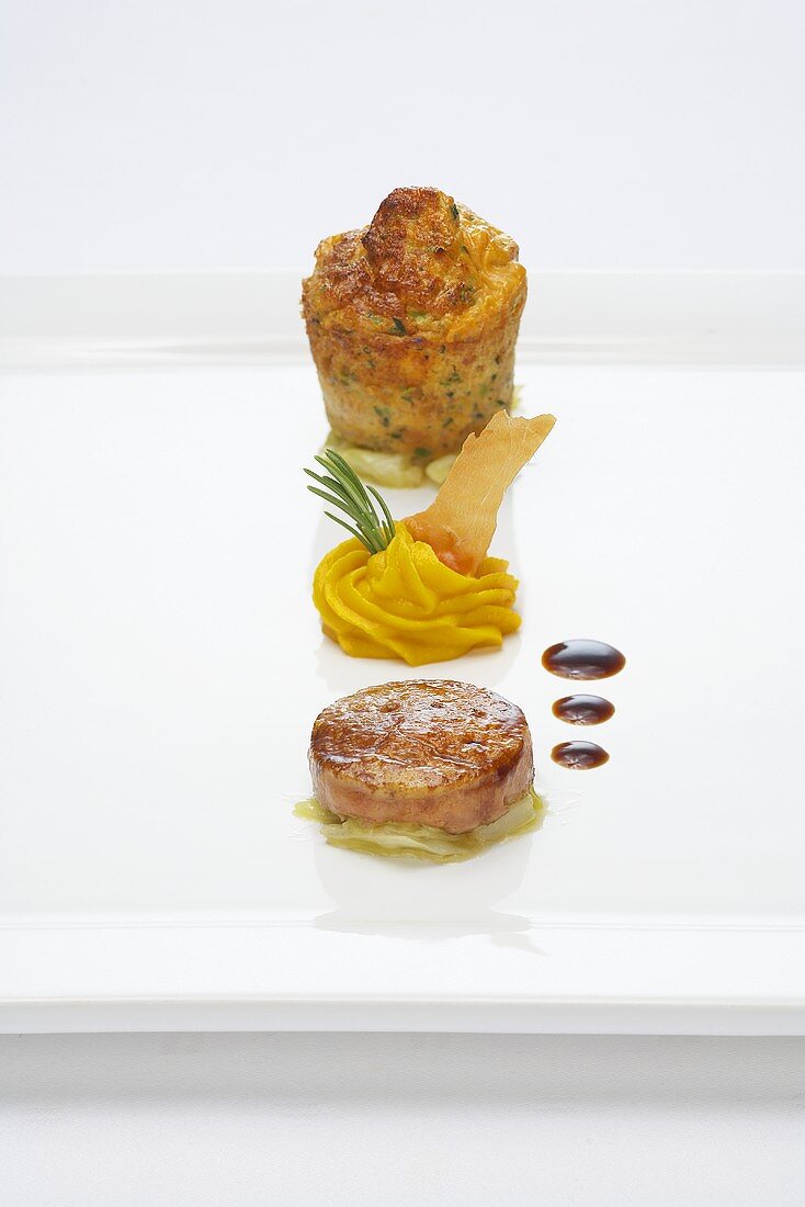 Pig stomach souffle with goose liver, pureed carrots and pointed cabbage