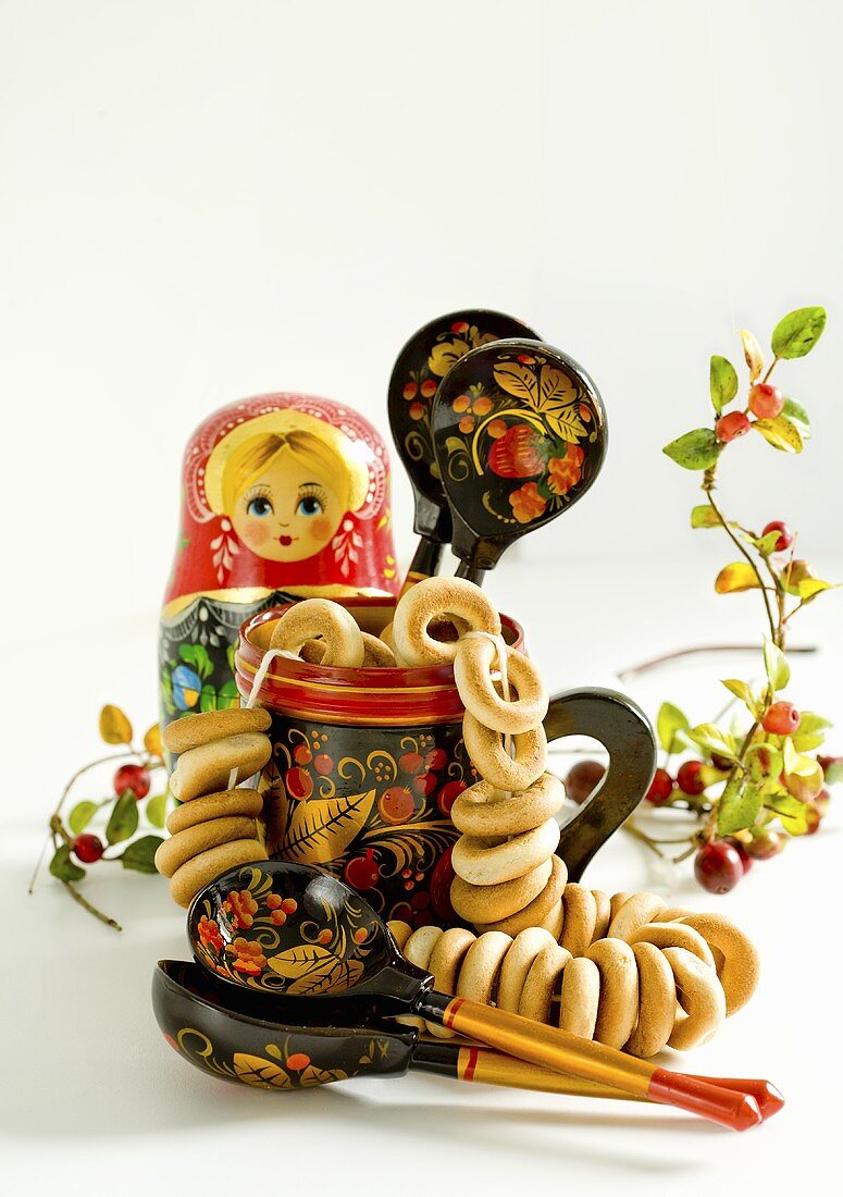 Bubliki (Russian bread rings) in a pot with a Matryoshka, wooden spoons and cranberries