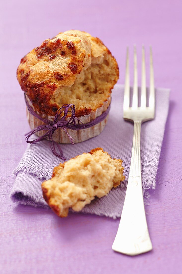 An apple and cinnamon muffin with a bite taken out