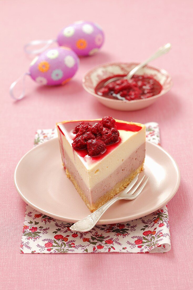 A slice of cheesecake with raspberries for Easter