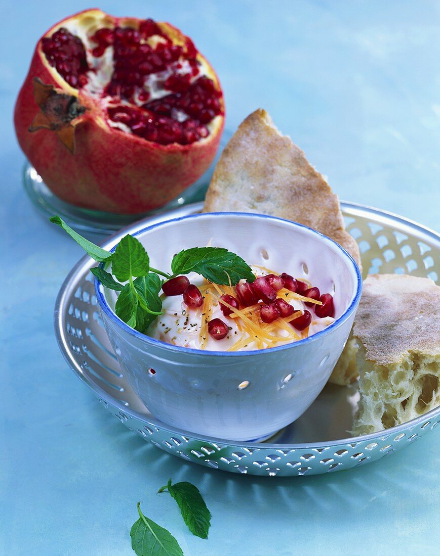 Carrot yoghurt with garlic and pomegranate seeds
