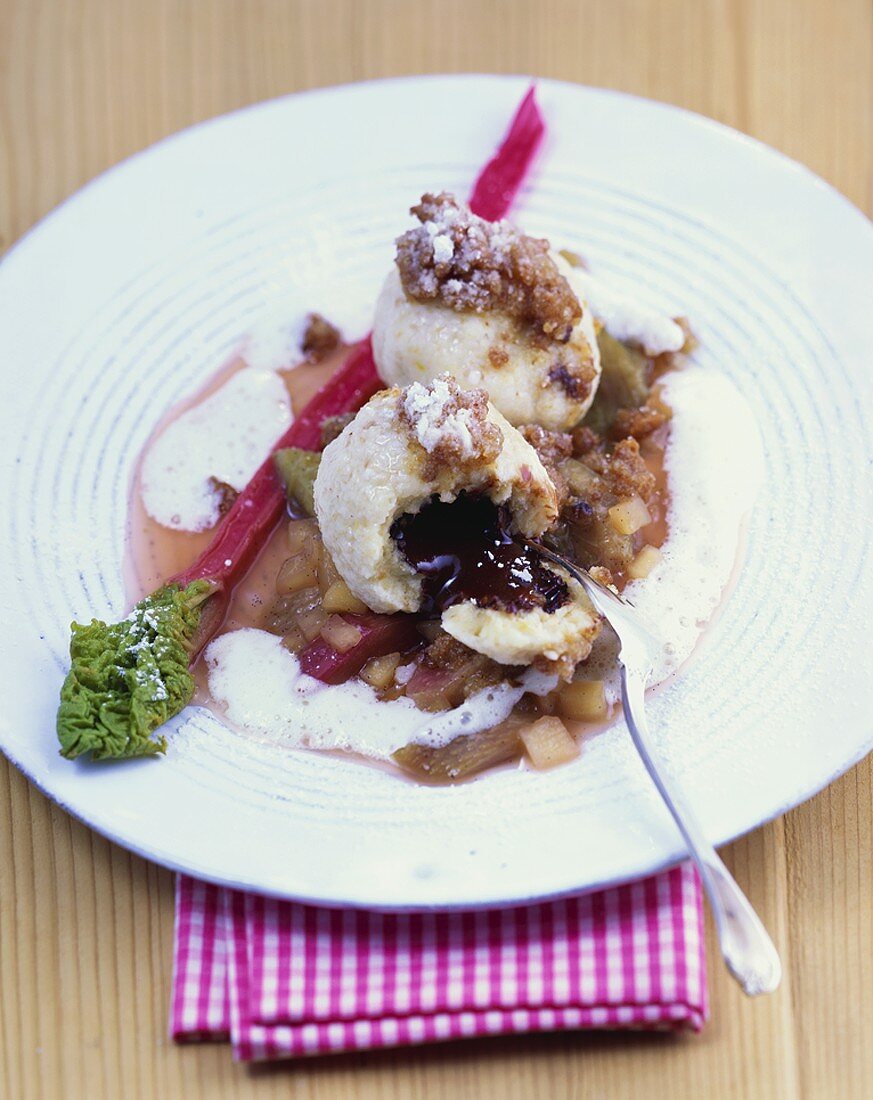 Chocolate-filled dumplings with amaretto crumbs & rhubarb compote