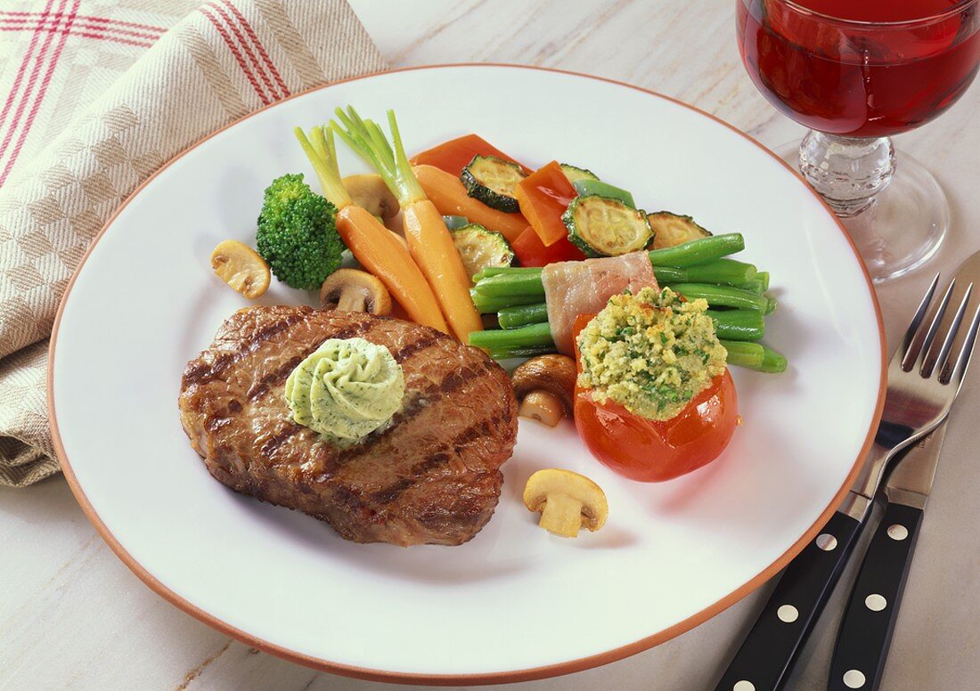 Beef steak with herb butter and vegetables