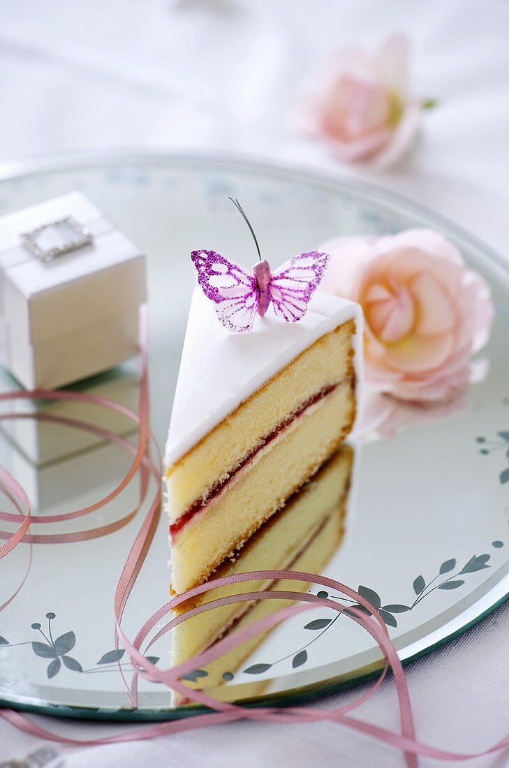 A piece of wedding cake with butterfly decoration