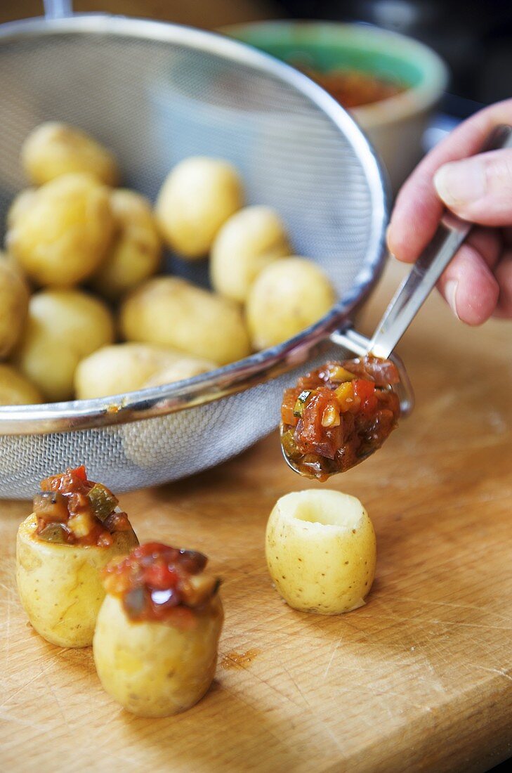 Stuffing new potatoes with salsa