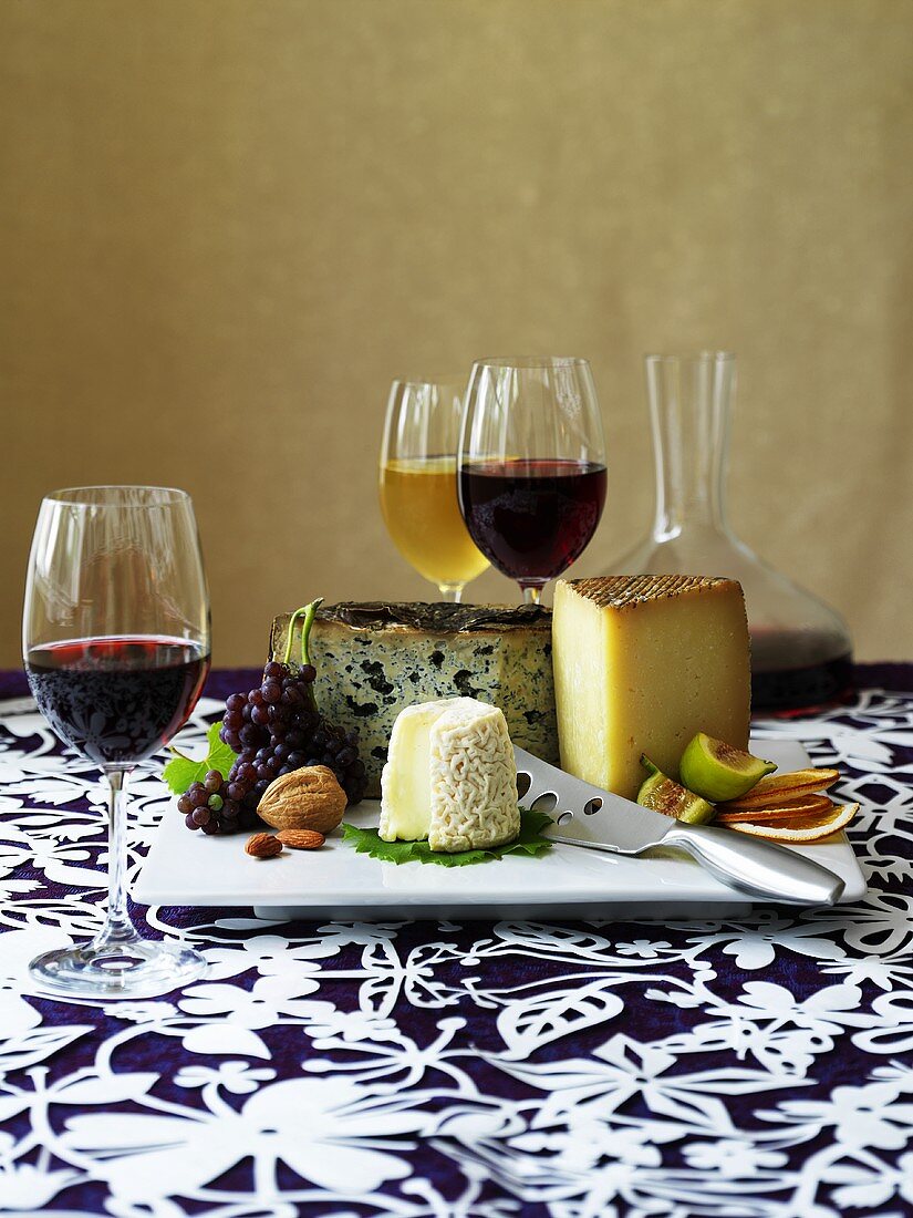 Cheese platter with fruit, nuts and wine