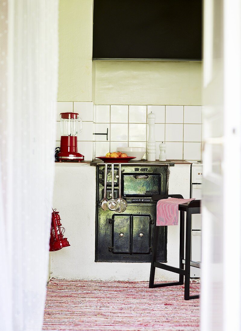 View into a kitchen with a wood-burning stove