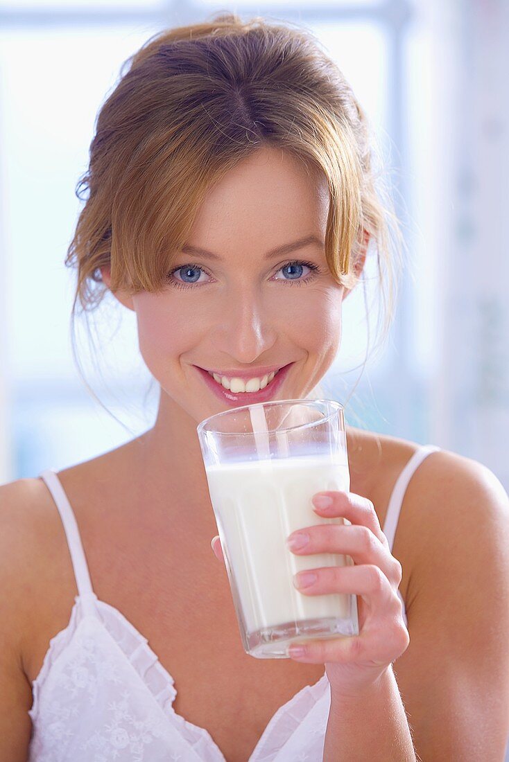 Junge Frau trinkt ein Glas Milch