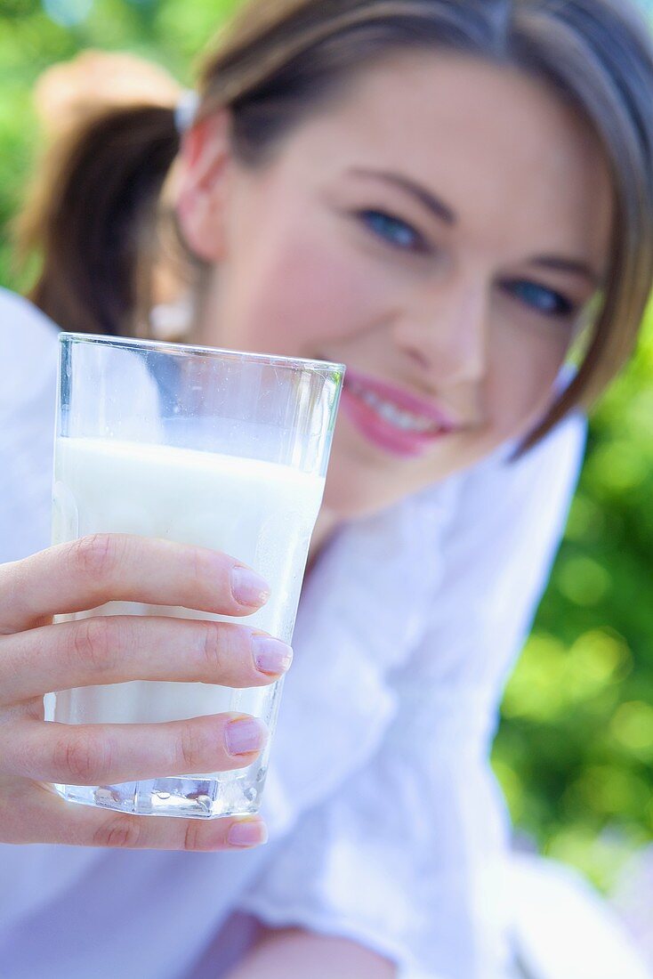 Young woman holding a glass of milk