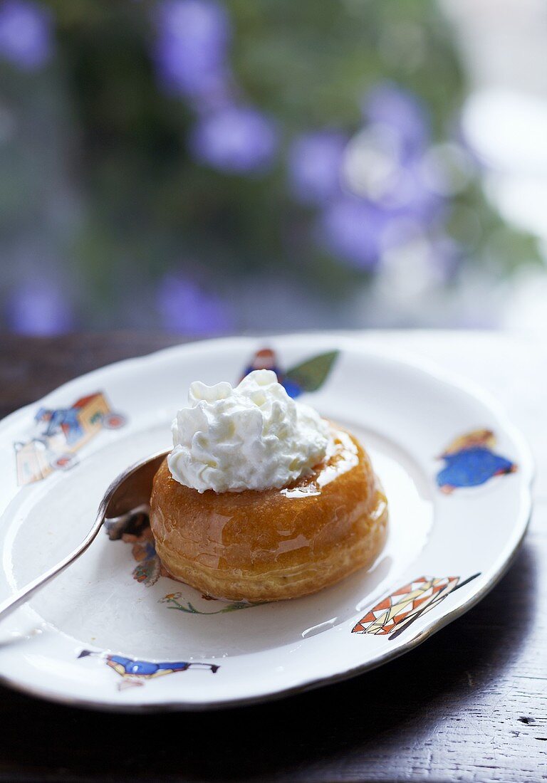 Baba au rhum (yeast cake soaked in rum) with cream