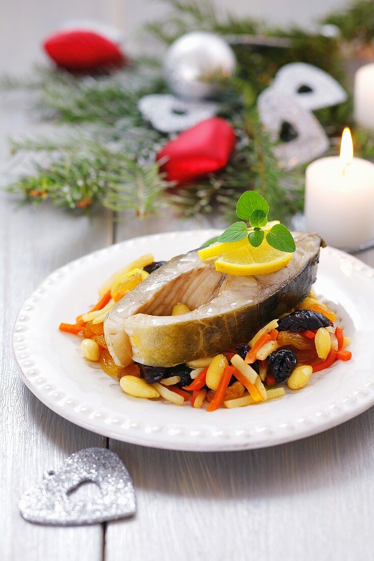 Carp on vegetables with raisins and pine nuts