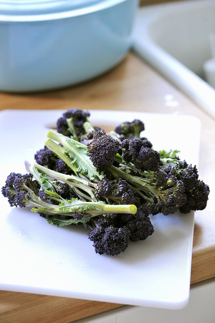 Purple broccoli on chopping board