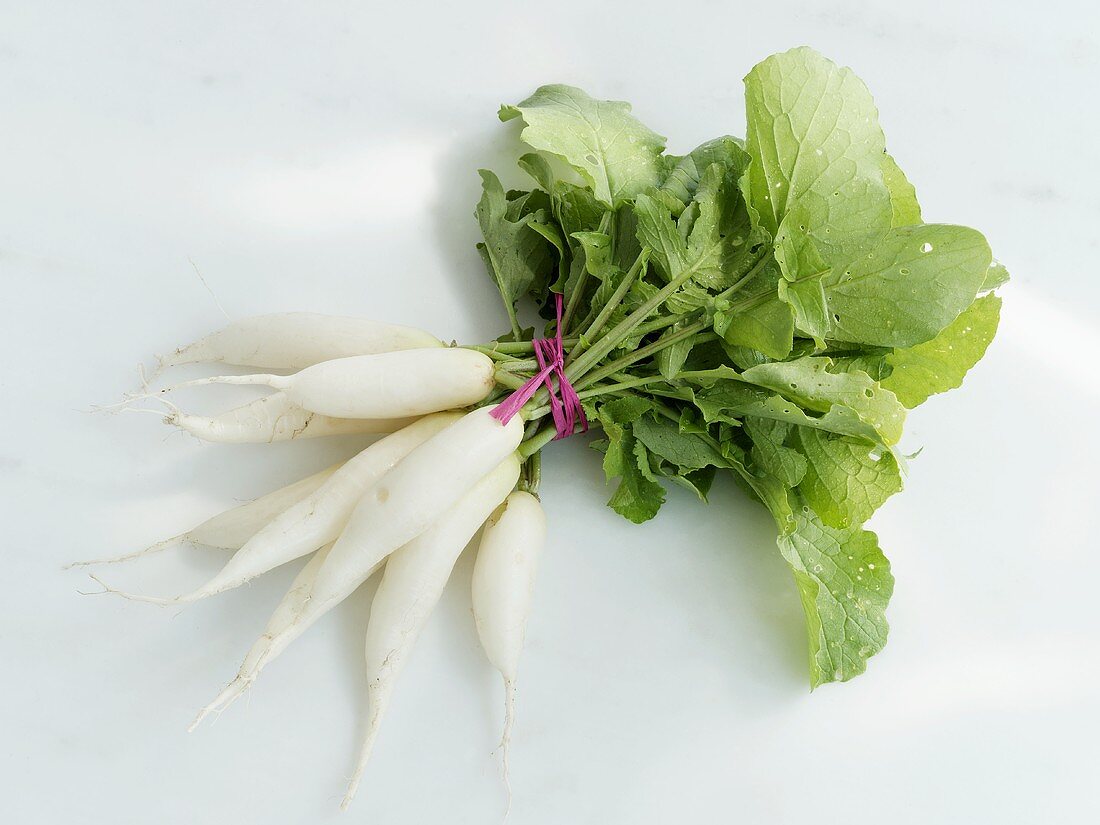 A bunch of white icicle radishes