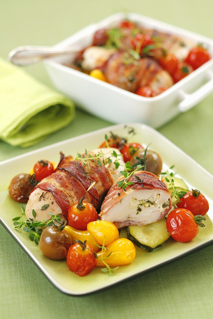 Stuffed, bacon-wrapped chicken breast with tomatoes and courgettes