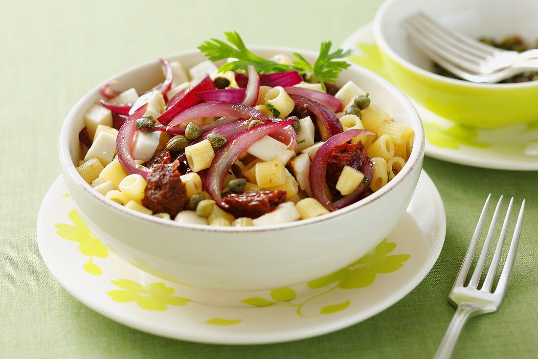 Pasta with caramelised onions, dried tomatoes, olives and feta