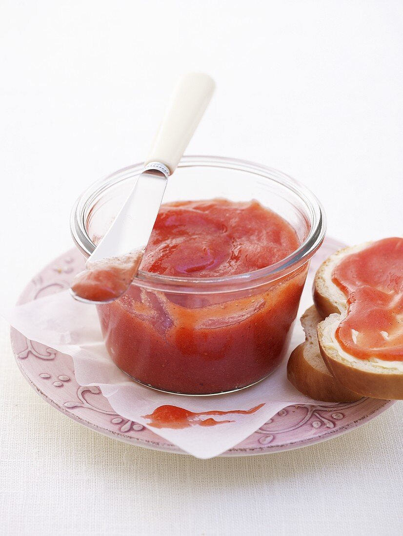 Strawberry cream spread in jar and on bread plait